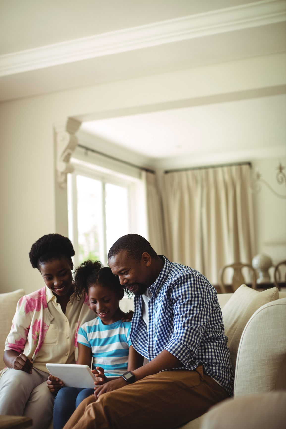 Family using digital tablet in living room